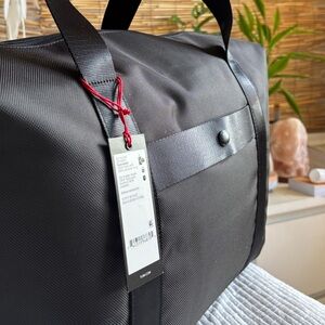 TUMI Black Travel Bag with Red Accents
